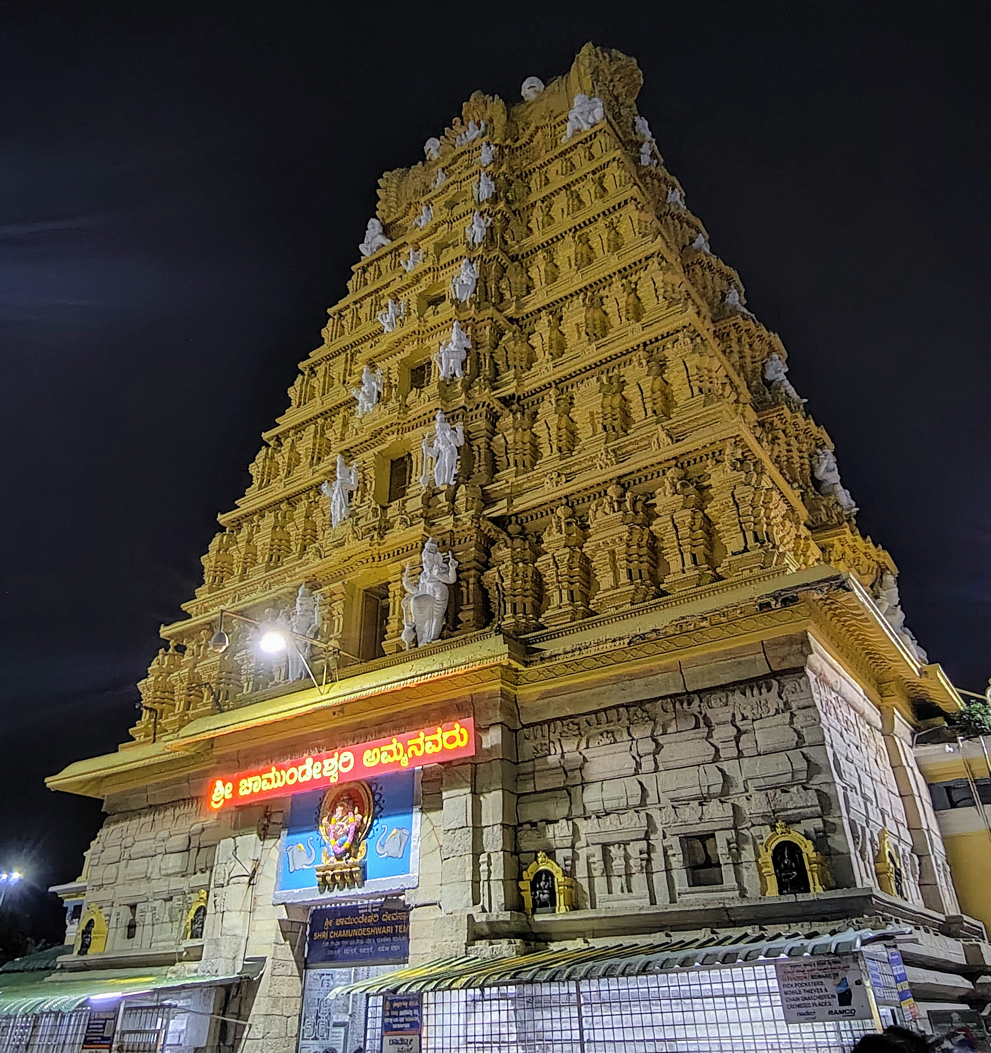 Night view of the sacred and majestic golden gopuram of Sri Chamundeshwari Temple in Mysuru