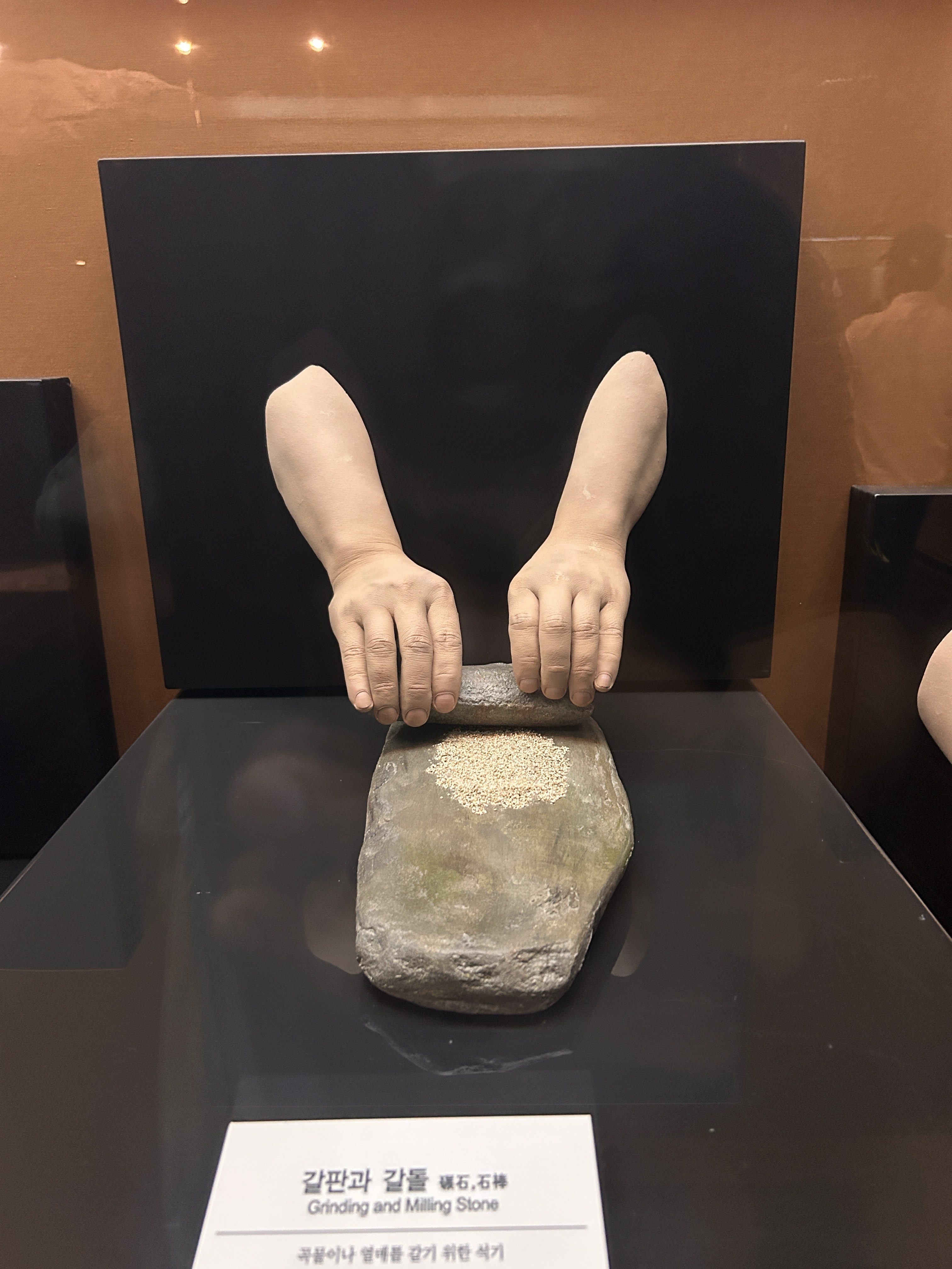 A close-up view of a display featuring a grinding and milling stone.