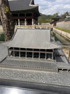 A detailed model of a traditional Asian-style building, featuring a sloped roof with multiple layers and intricate texturing. 
