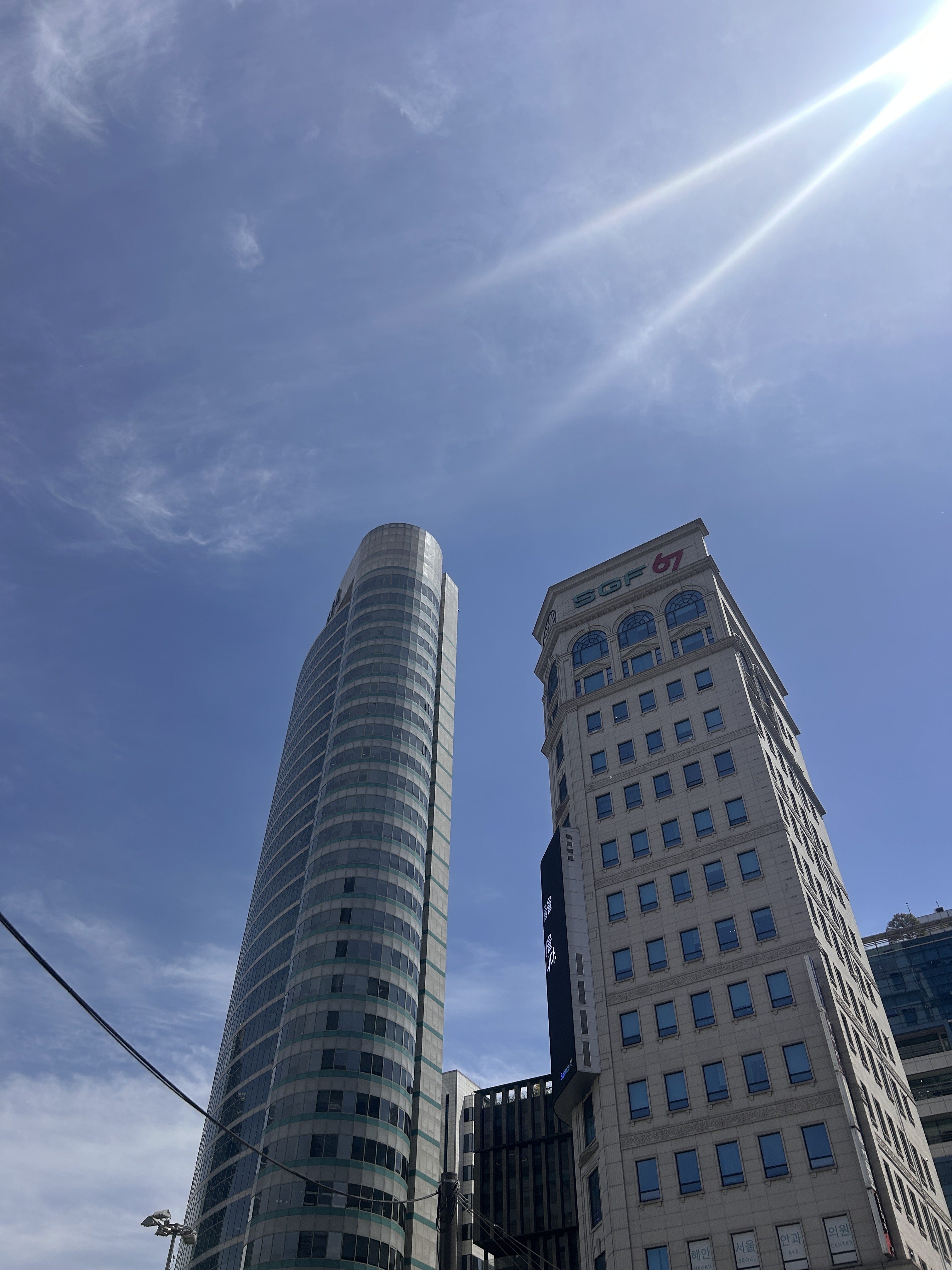 Modern buildings against a clear blue sky.