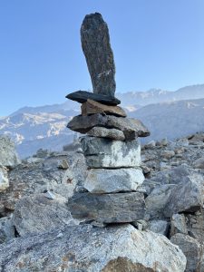 A balanced stack of stones in a mountainous landscape.
