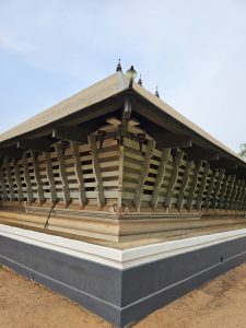 The side view of the Koothambalam (temple theatre or play house) of Vadakkunnathan Temple, located in Thrissur, Kerala. This ancient Hindu temple, dedicated to Lord Shiva, showcases traditional Kerala architectural style with its distinct roof structure and wooden detailing. 
