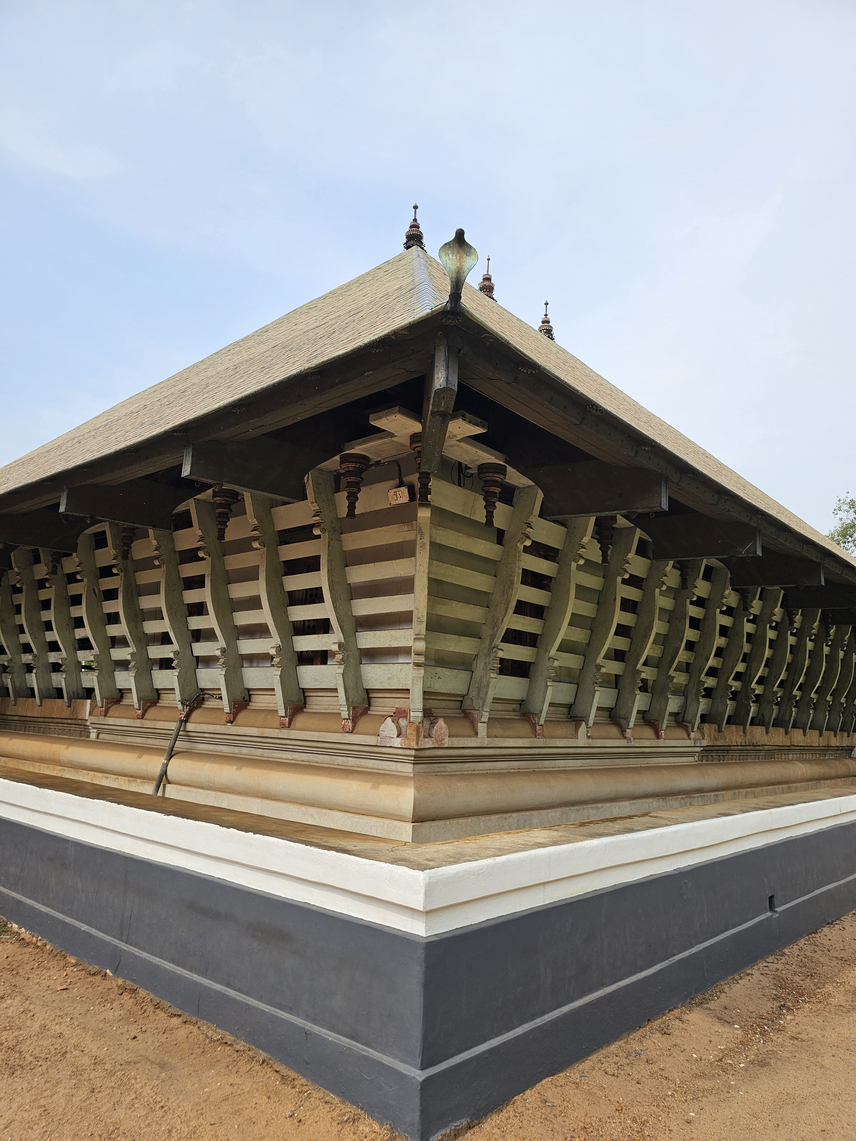 The side view of the Koothambalam (temple theatre or play house) of Vadakkunnathan Temple, located in Thrissur, Kerala. This ancient Hindu temple, dedicated to Lord Shiva, showcases traditional Kerala architectural style with its distinct roof structure and wooden detailing. 
