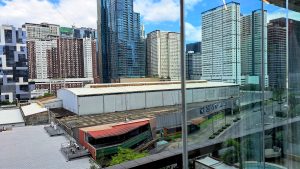 A view of a modern urban landscape featuring tall residential and commercial buildings with glass facades.