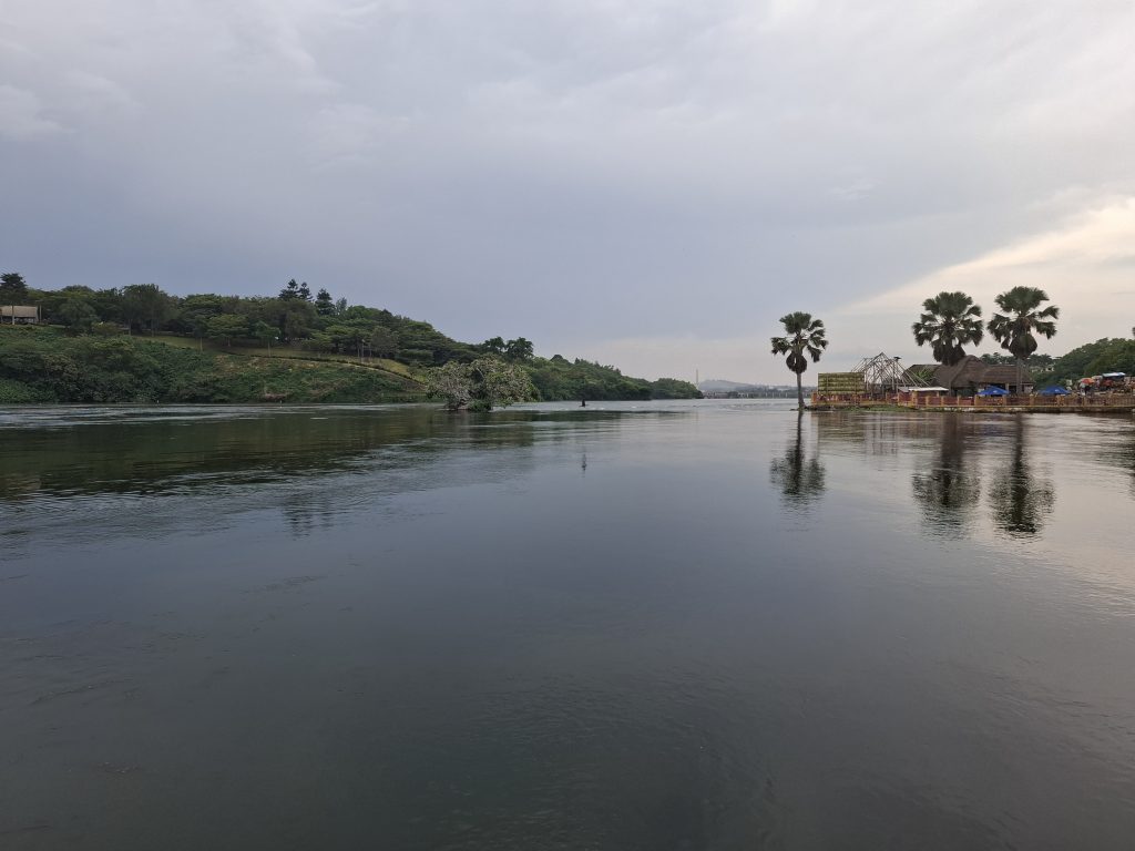 A tranquil Nile river scene featuring calm waters reflecting the surrounding landscape.