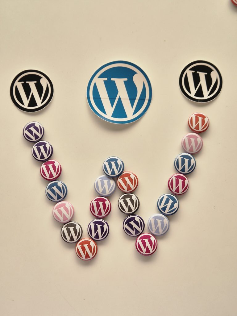 An assortment of WordPress-related logos and buttons arranged on a white background.