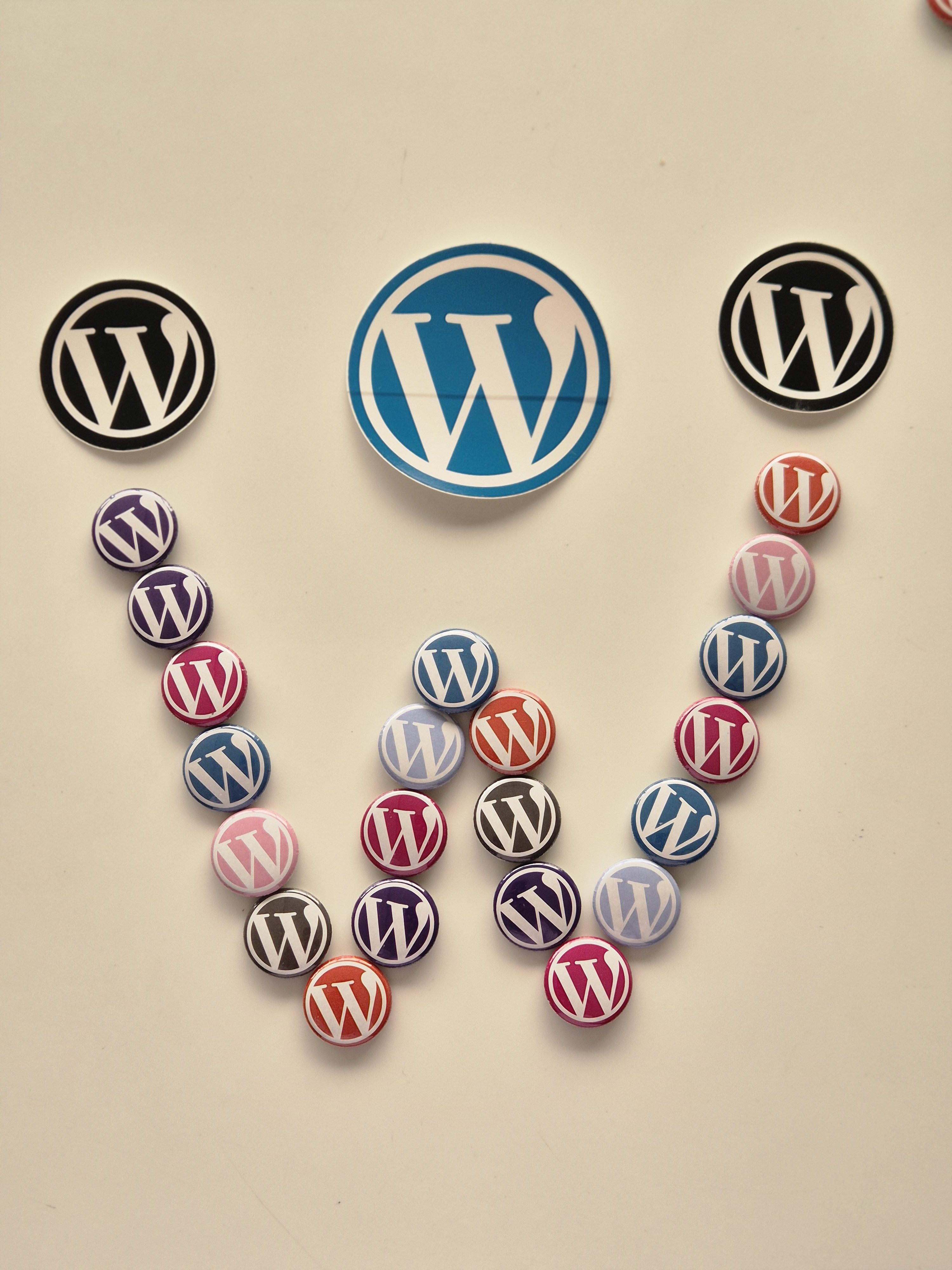 An assortment of WordPress-related logos and buttons arranged on a white background.