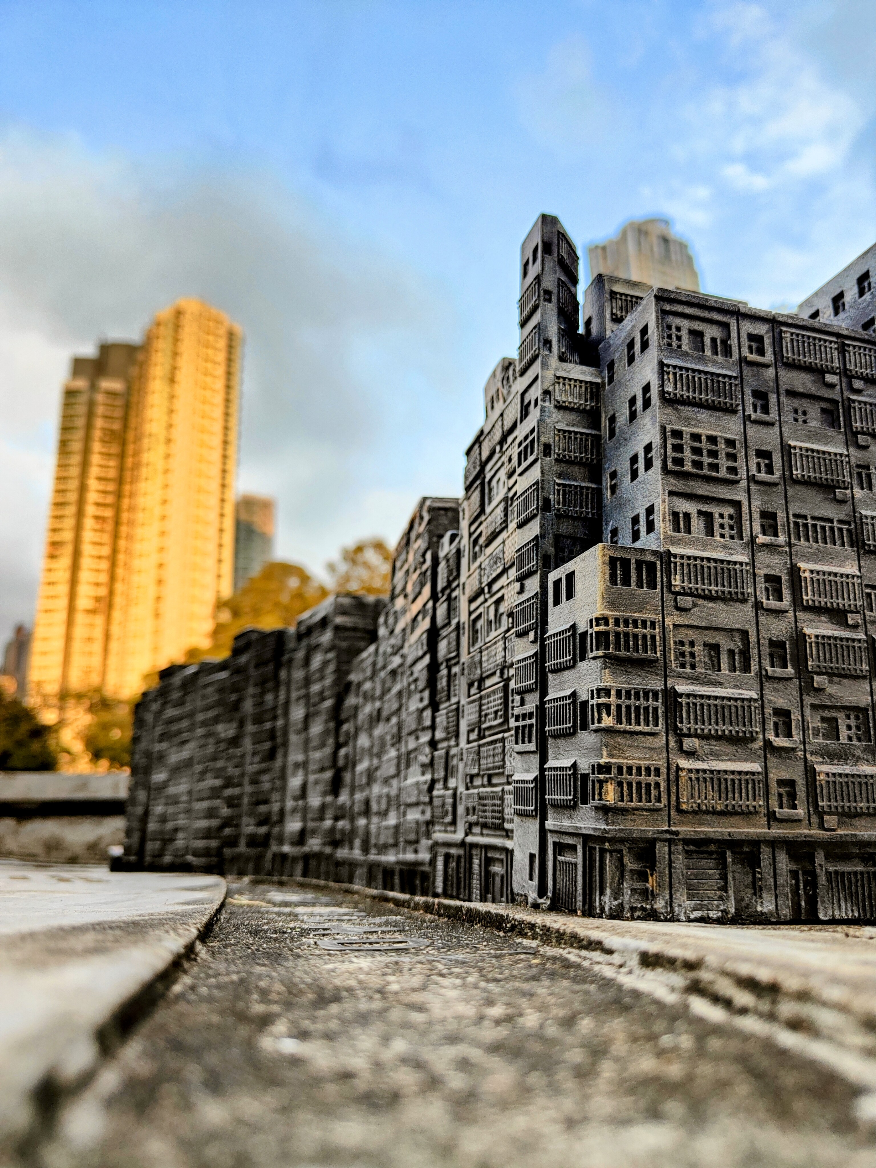 A glimpse into the past - miniature replica of Kowloon Walled City, once the world's most densely populated place, standing in stark contrast to modern Hong Kong's skyline.
