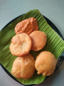 Aloo Bajji is a common street food and a tea-time snack in India, particularly in South India. It is often enjoyed during special occasions and festivals. The dish is served on a banana leaf with a side of chutney.
