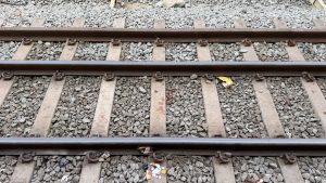 A close-up view of railroad tracks laid on a bed of gravel.