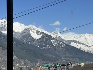 A scenic view of snow-capped mountains under a clear blue sky.