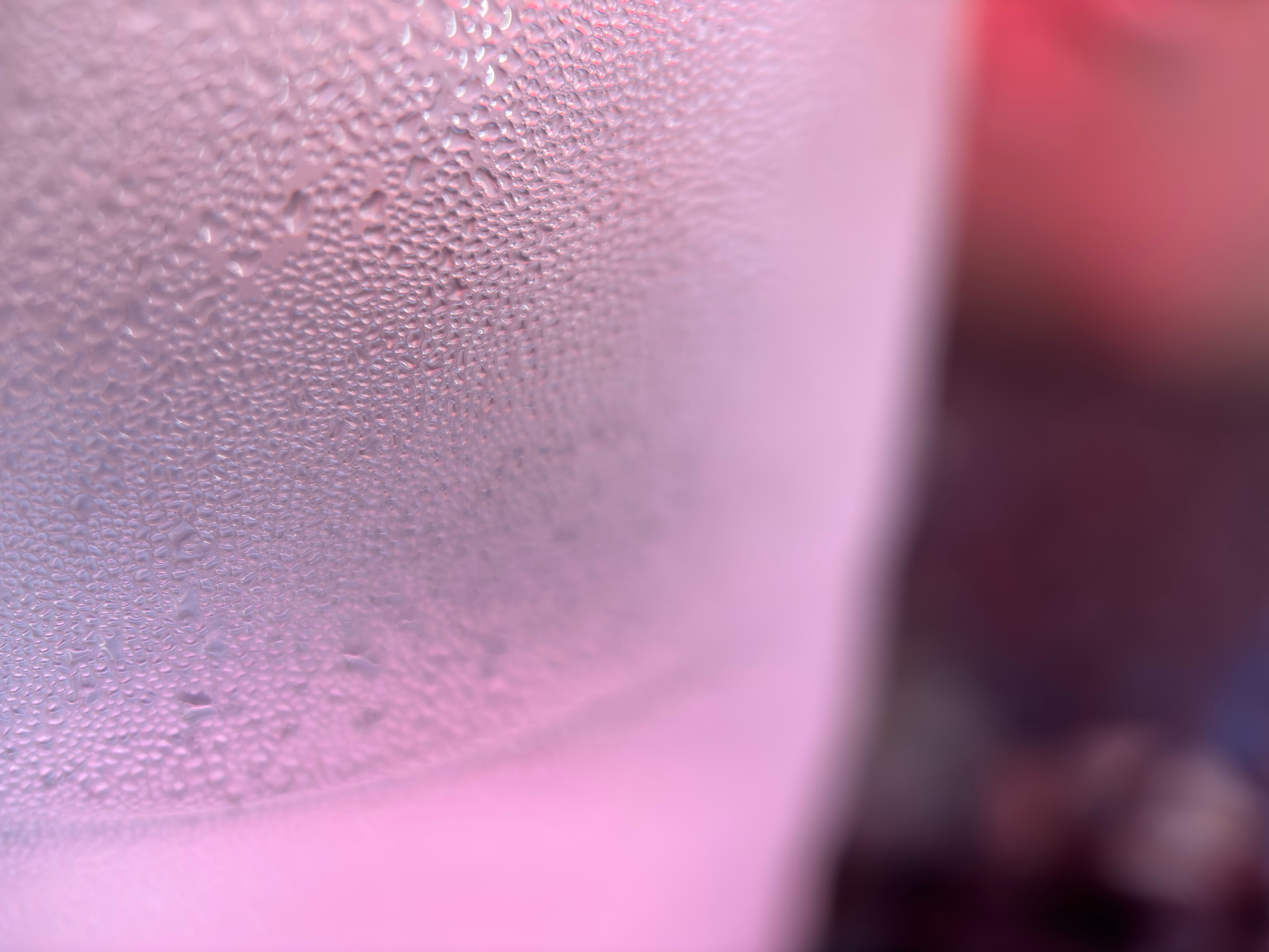 Closeup of water beads on a glass of water.