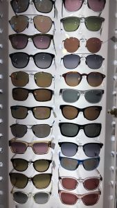 Two columns of sunglasses on display.