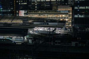 The brightly lit night view of Tokyo Midtown Yaesu. Right in front of it is Tokyo Station, where several Shinkansen trains are parked.