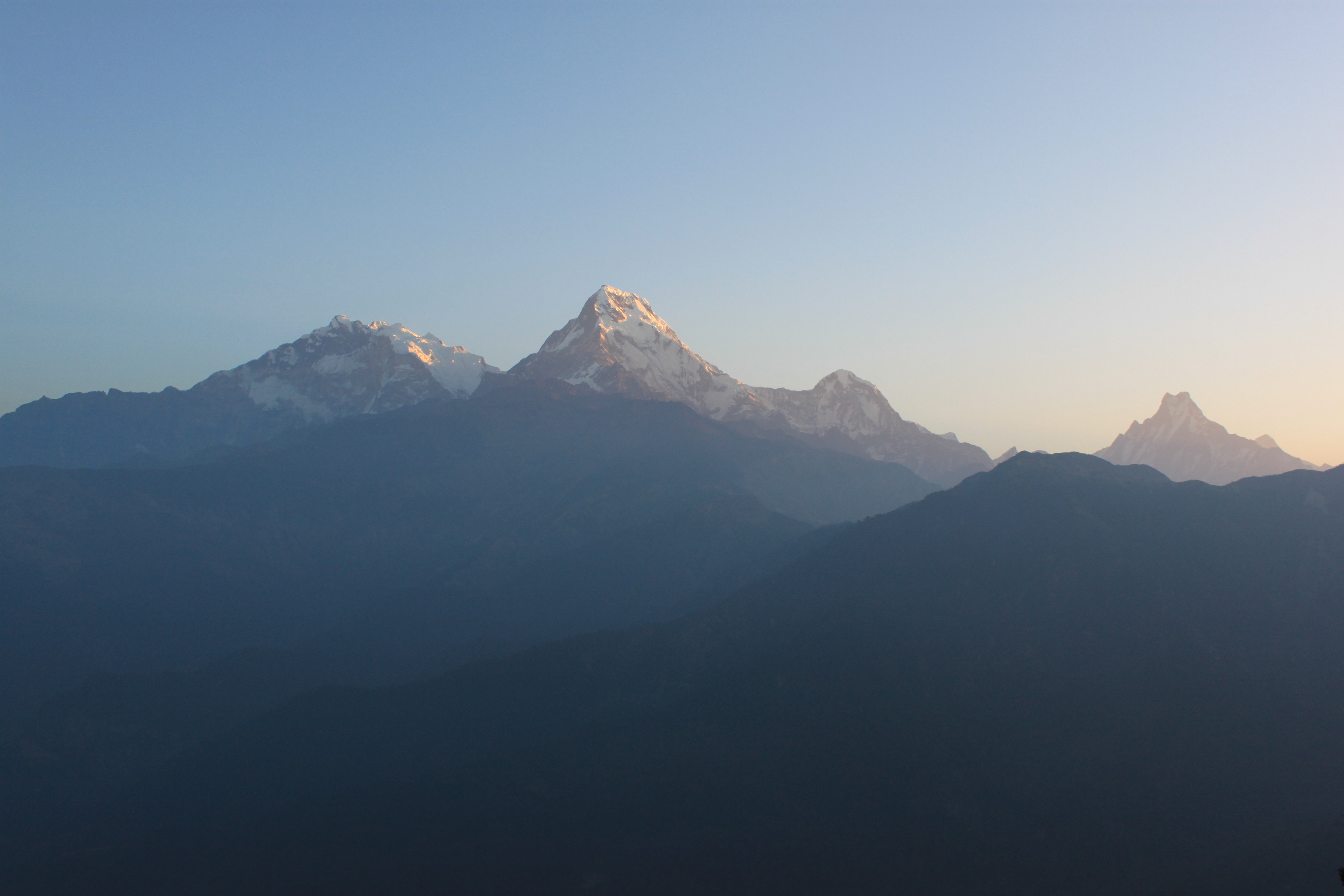 A panoramic view of majestic mountains at sunrise.