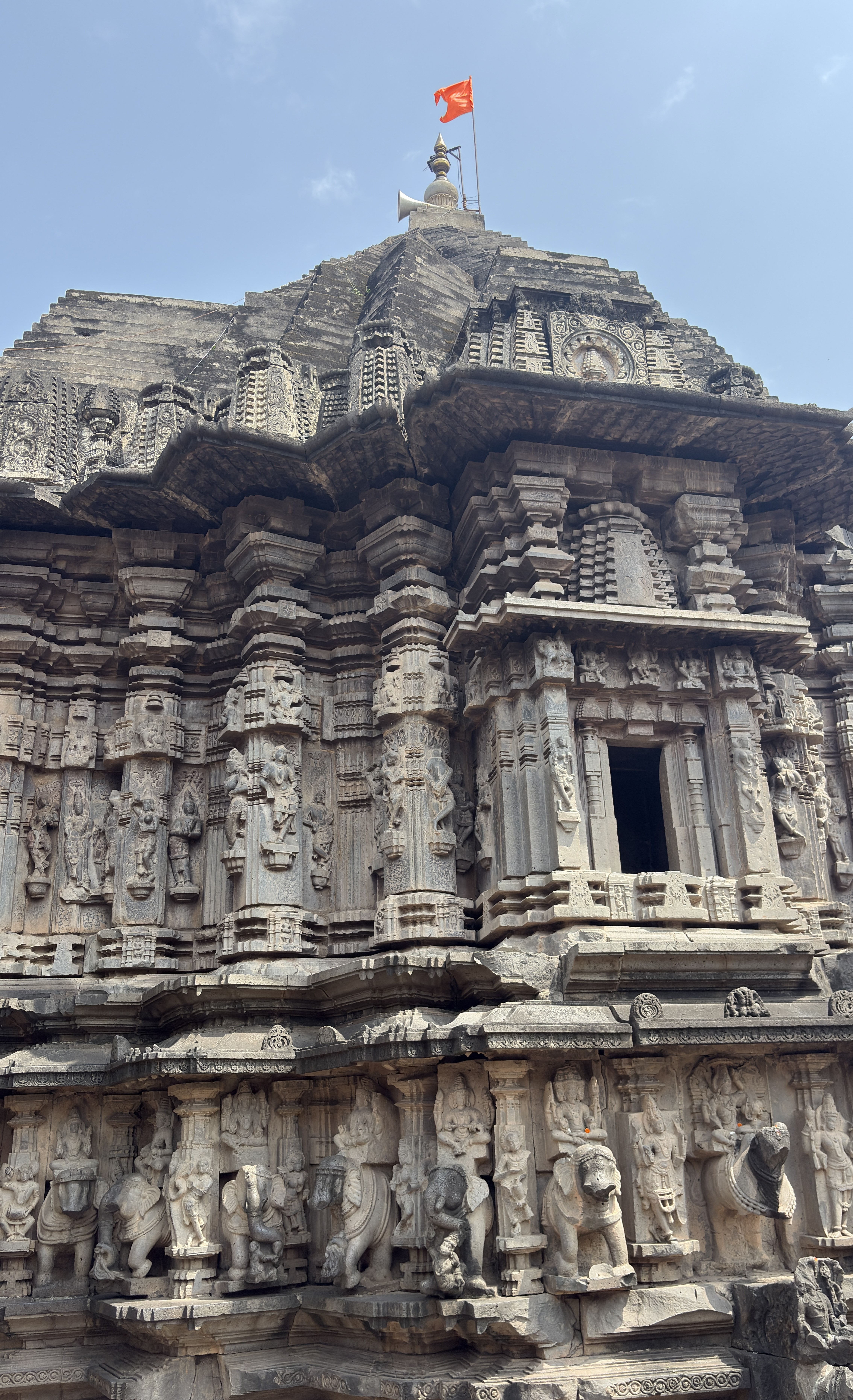 A close-up view of a beautifully intricately carved temple structure featuring various stone sculptures of deities and mythical creatures