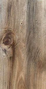 Faded wood grain, a large knot on the left side.