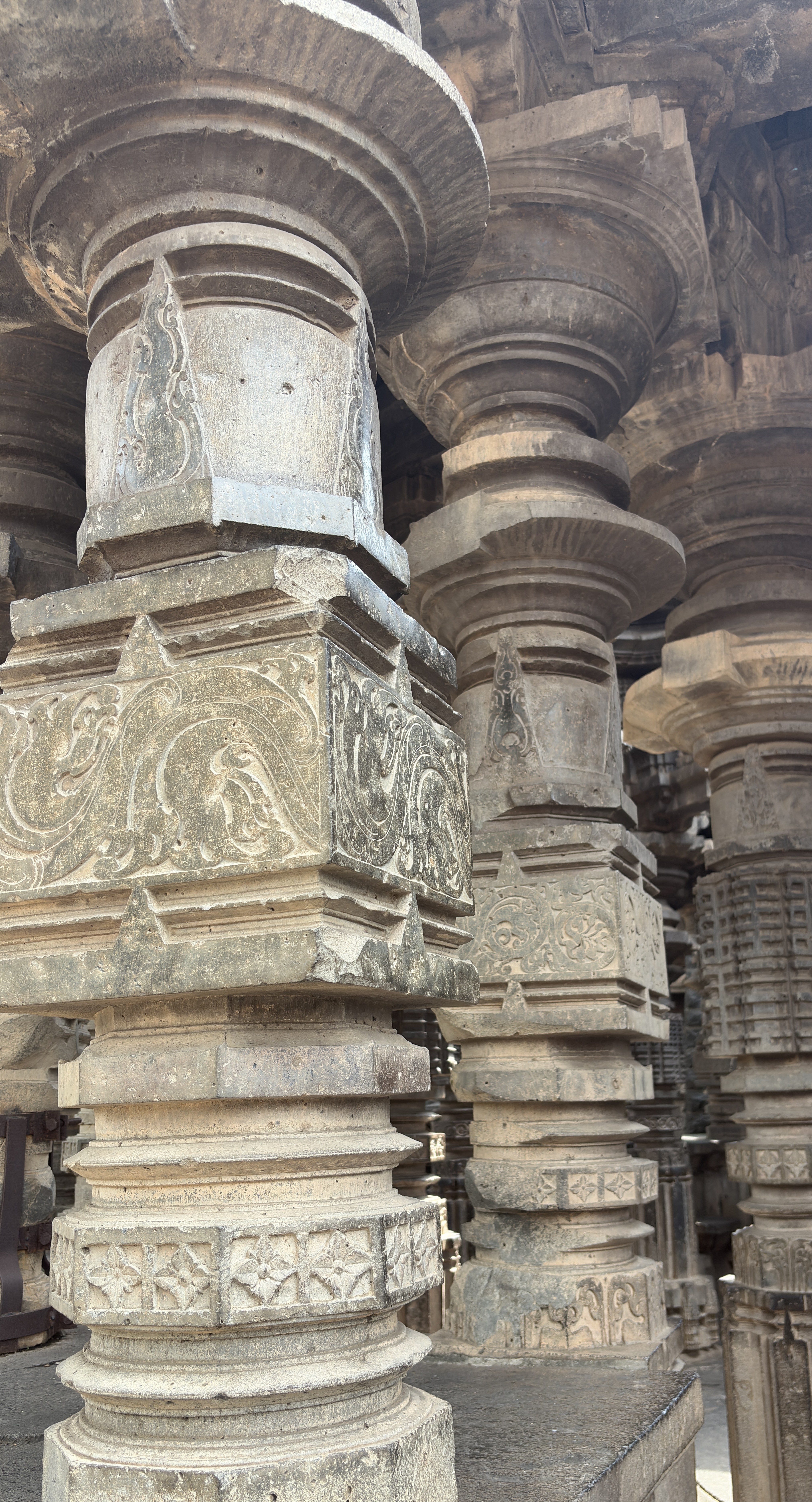 A close-up view of intricately carved stone pillars, featuring detailed decorative patterns and motifs.