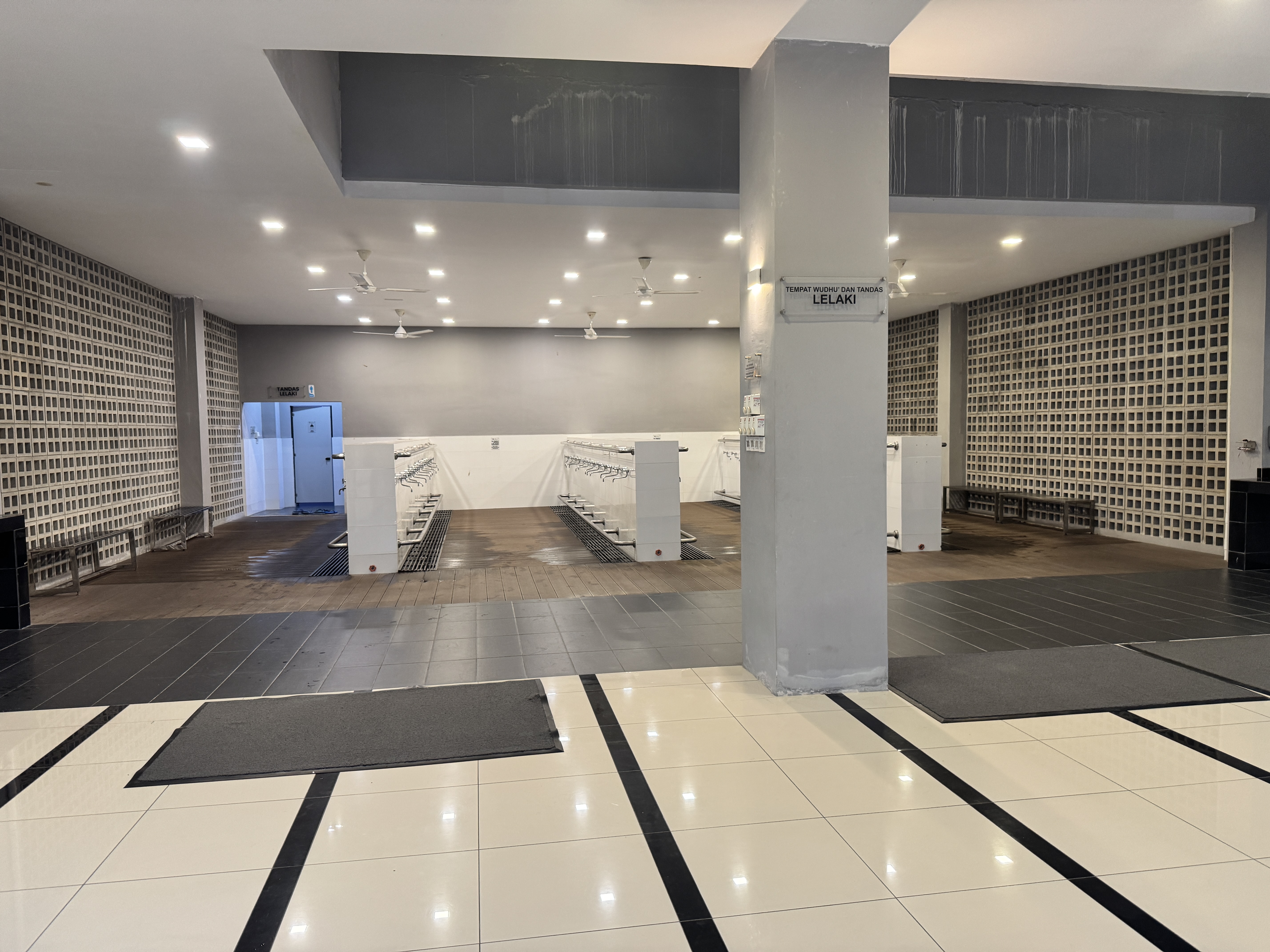 An indoor space featuring a large tiled floor with black and white patterns.