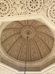 An intricately designed ceiling featuring ornate carvings and patterns. 