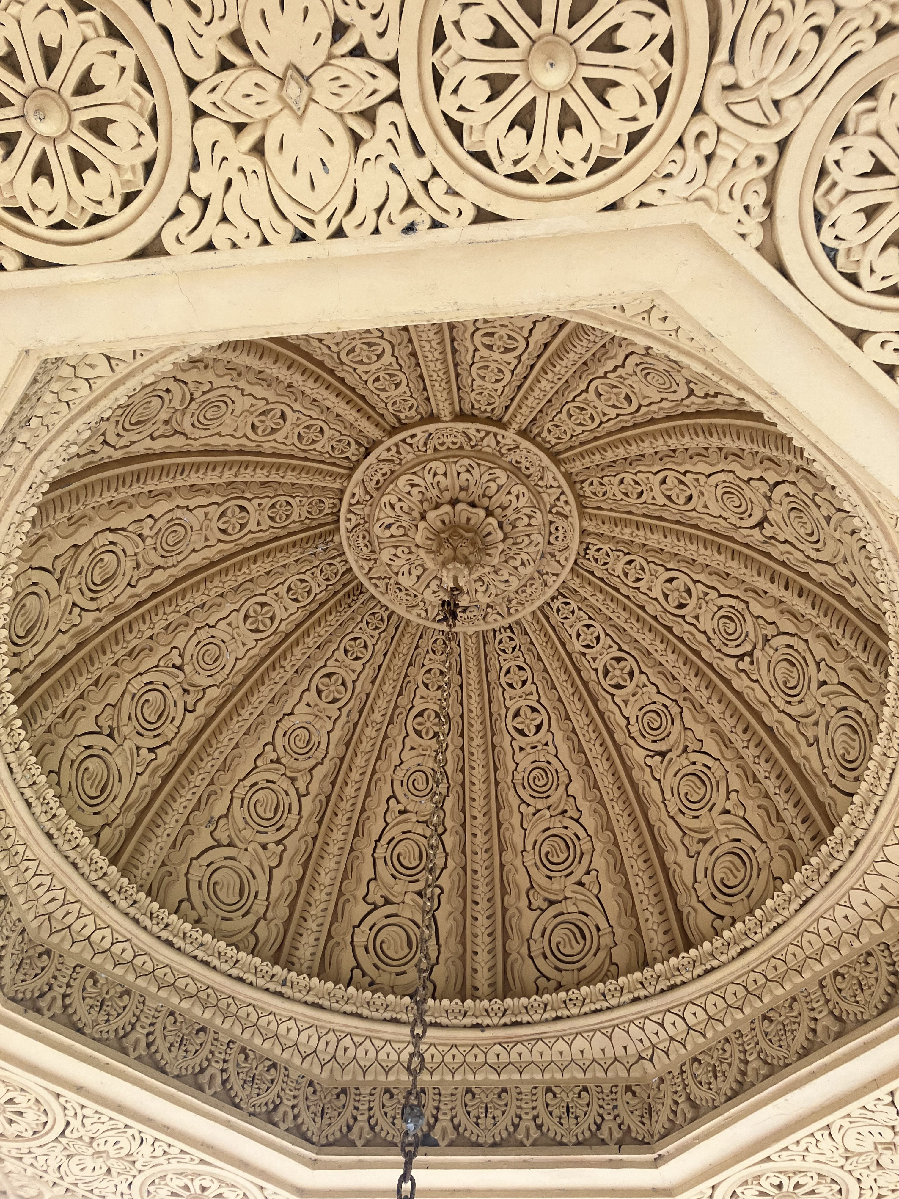 An intricately designed ceiling featuring ornate carvings and patterns.