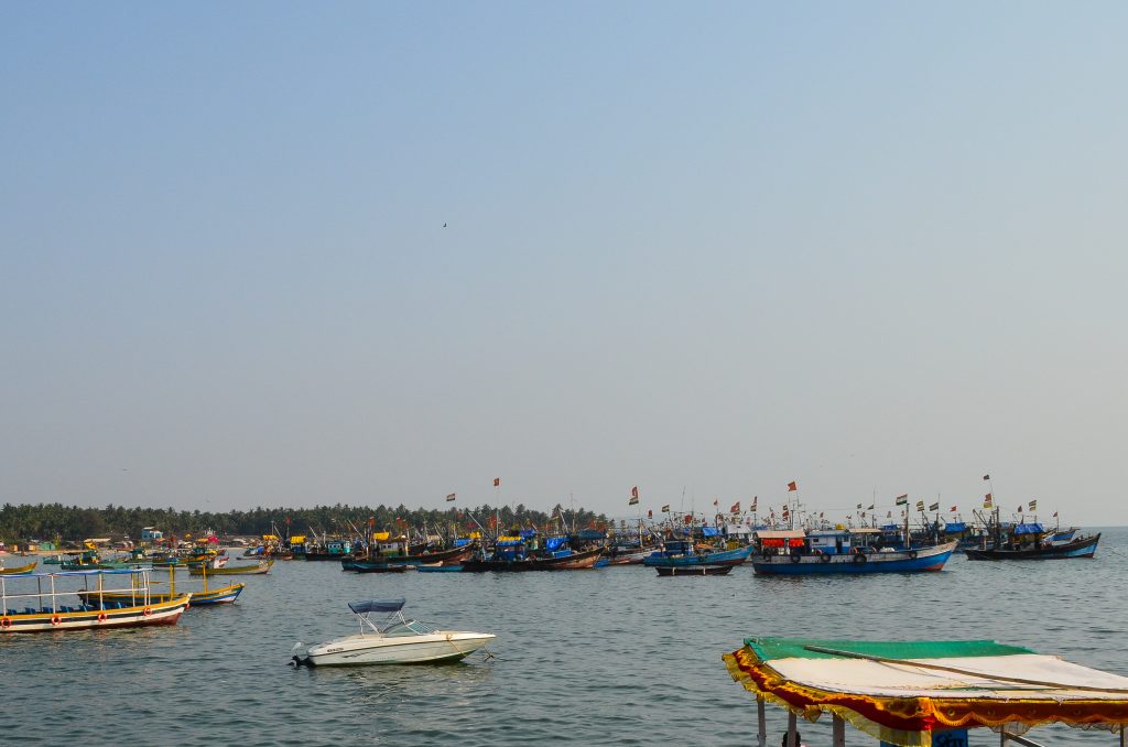 A picturesque scene of a harbor filled with various fishing boats, some adorned with colorful flags.
