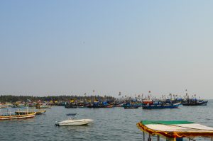 A picturesque scene of a harbor filled with various fishing boats, some adorned with colorful flags.