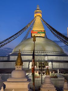 A night view of Boudhanath Stupa, often referred to as Boudha or Boudhanath with mesmerizing blue sky. 
