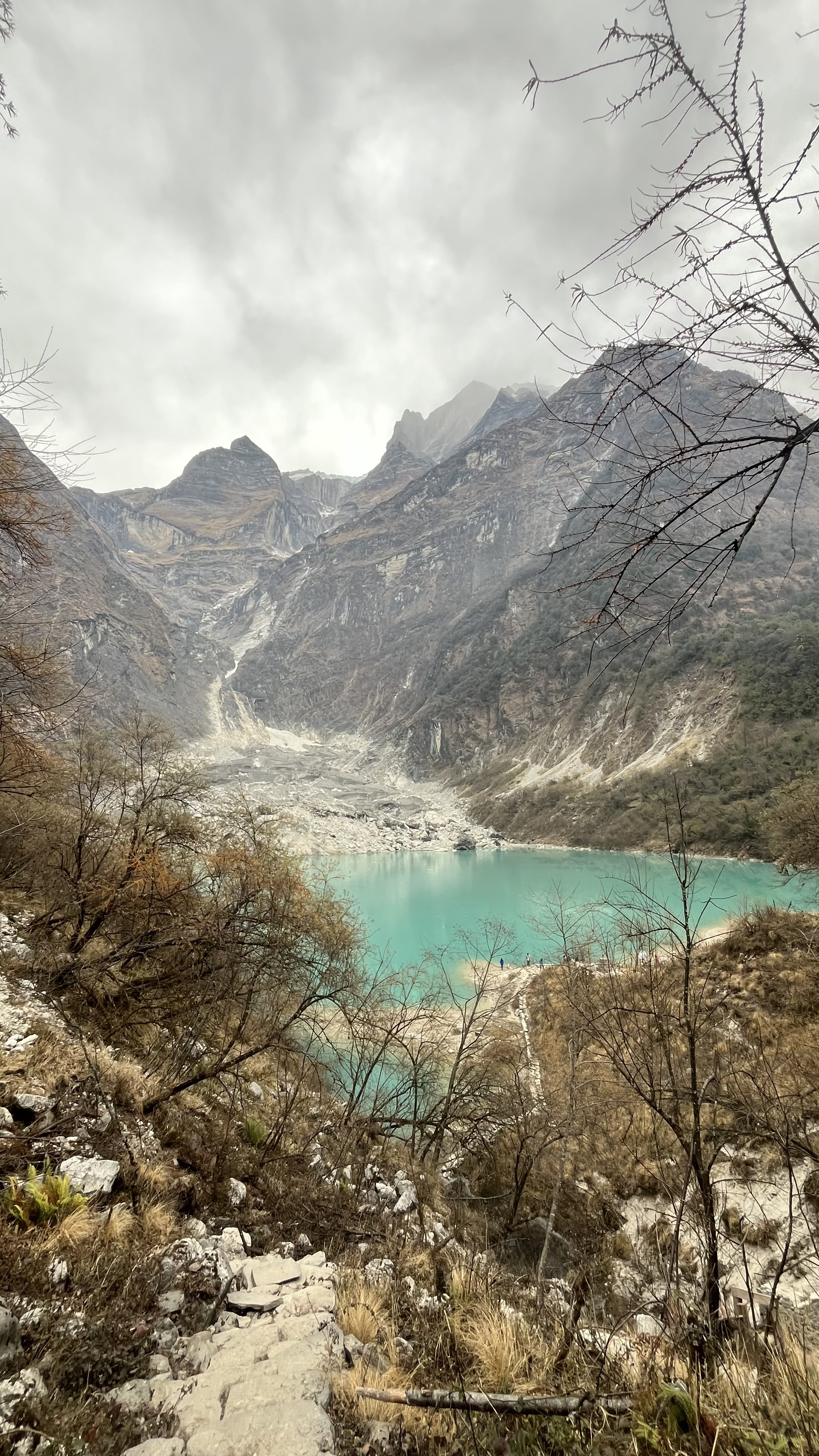 A breathtaking landscape featuring a serene turquoise lake nestled between rugged mountains.