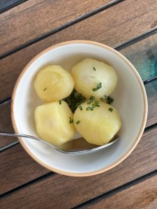 Four pieces of potatoes in a bowl ready to serve for the restaurant customers in a restuarant of Germany.