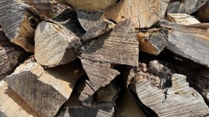The cut and split ends of firewood, stacked neatly.