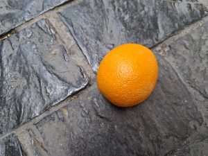 Yellow fruit on the on a gray floor.