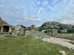 Ancient stone ruins and rocky paths lead up boulder-strewn Matanga Hill in Hampi, India.