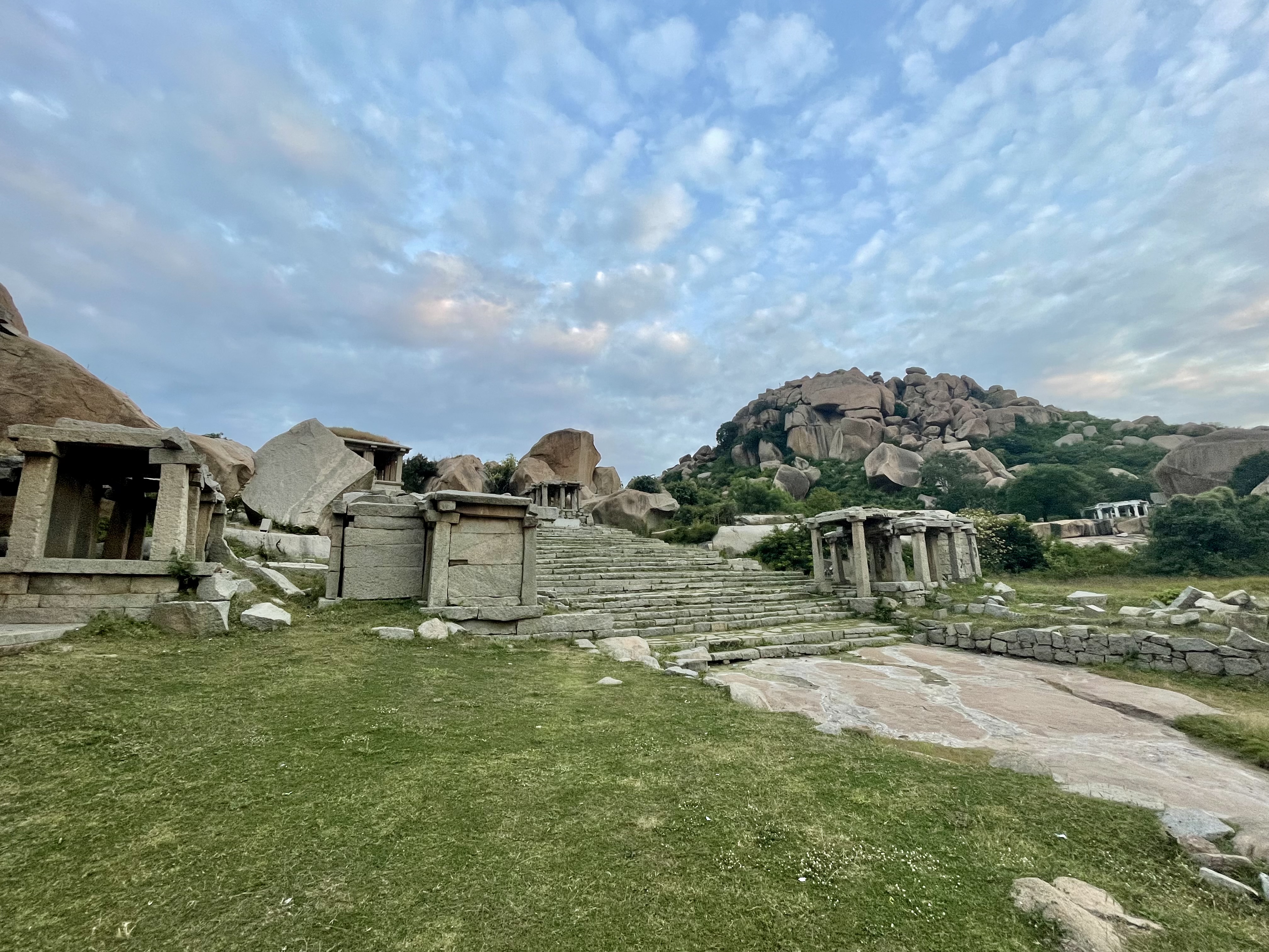 Ancient stone ruins and rocky paths lead up boulder-strewn Matanga Hill in Hampi, India.