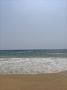 A serene beach scene with gentle waves lapping at the shore.
