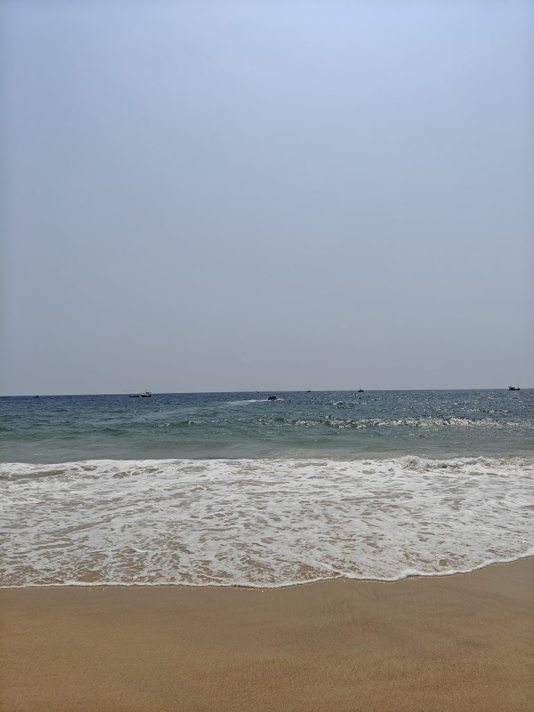 A serene beach scene with gentle waves lapping at the shore.