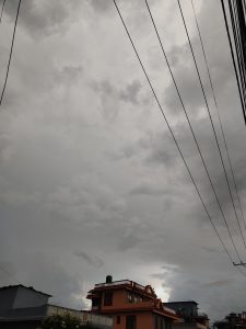 A cloudy sky dominates the image, with various shades of gray creating a dramatic atmosphere