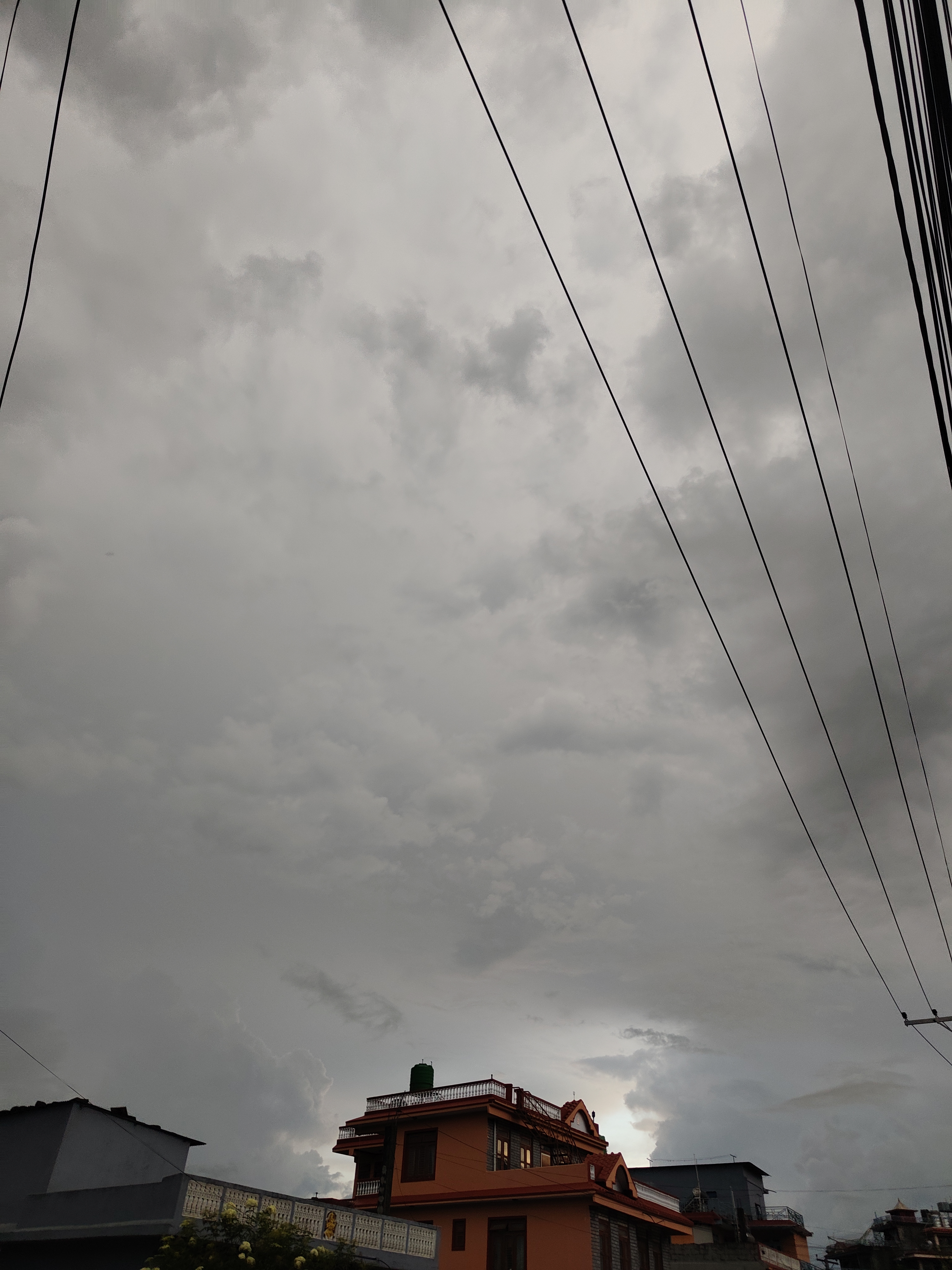 A cloudy sky dominates the image, with various shades of gray creating a dramatic atmosphere