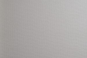 Close-up photo of light gray woven wallpaper texture