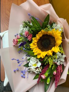 A bouquet of flowers with big sunflower