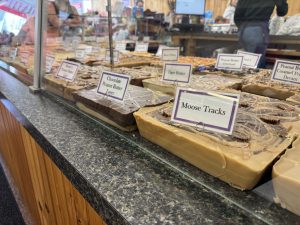 A counter with many different flavors of fudge behind a glass panel at Chutters in Littleton, New Hampshire.