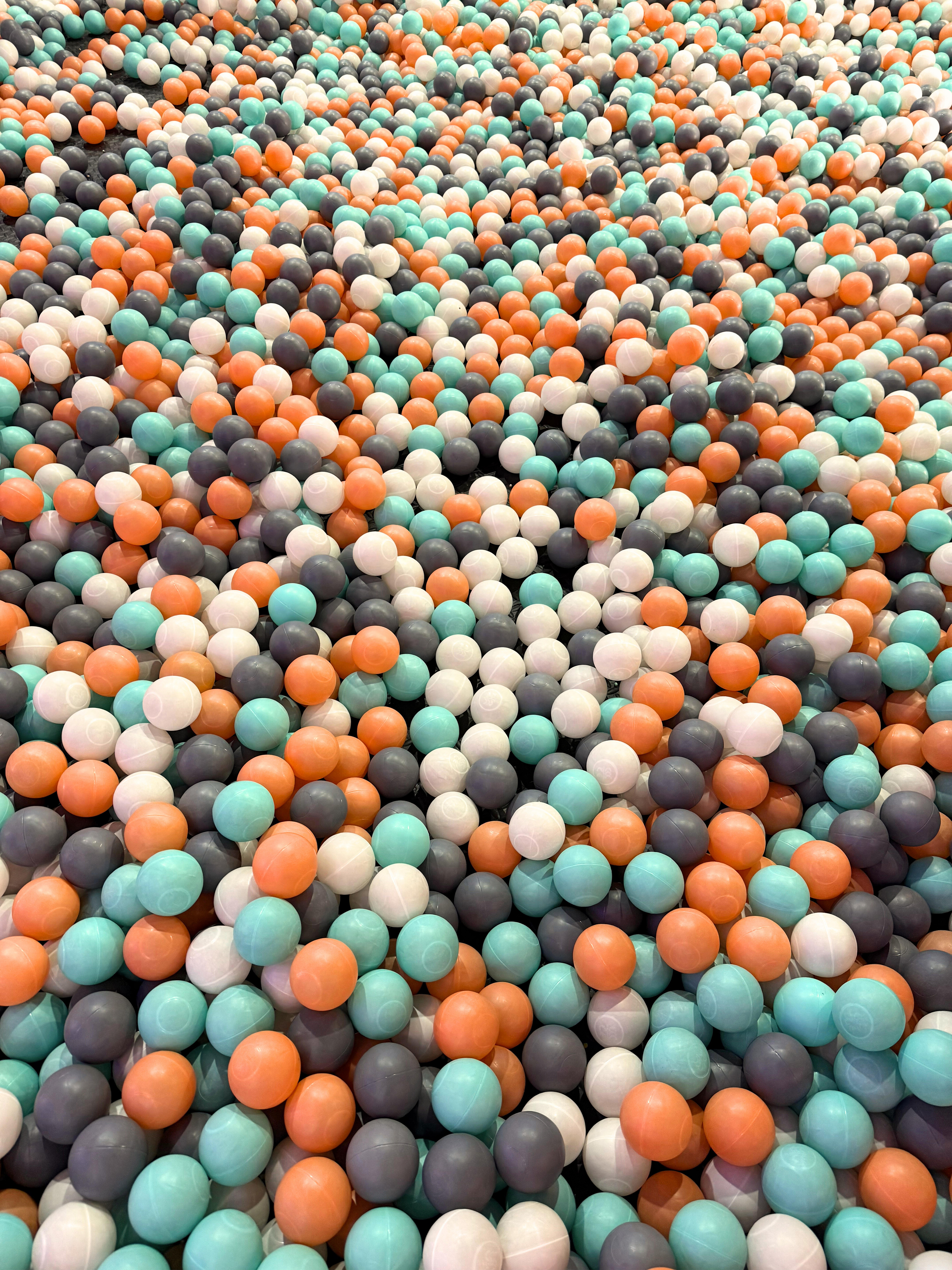 A vibrant collection of plastic balls in various colors filling the frame.