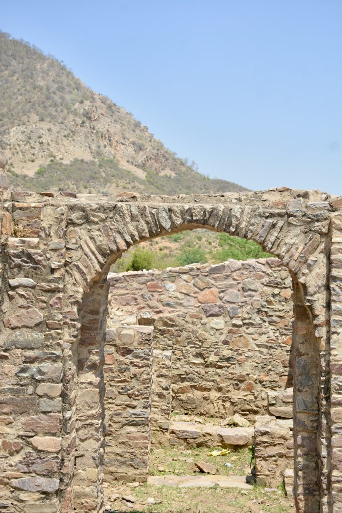 Ancient stone archway at Bhangarh Fort, Rajasthan, weathered by centuries yet standing proud.