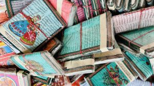 A collection of handmade paper notebooks wrapped in plastic, displayed for sale in Jaipur, India.
