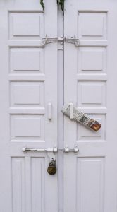 newspaper on white door of a shop in India