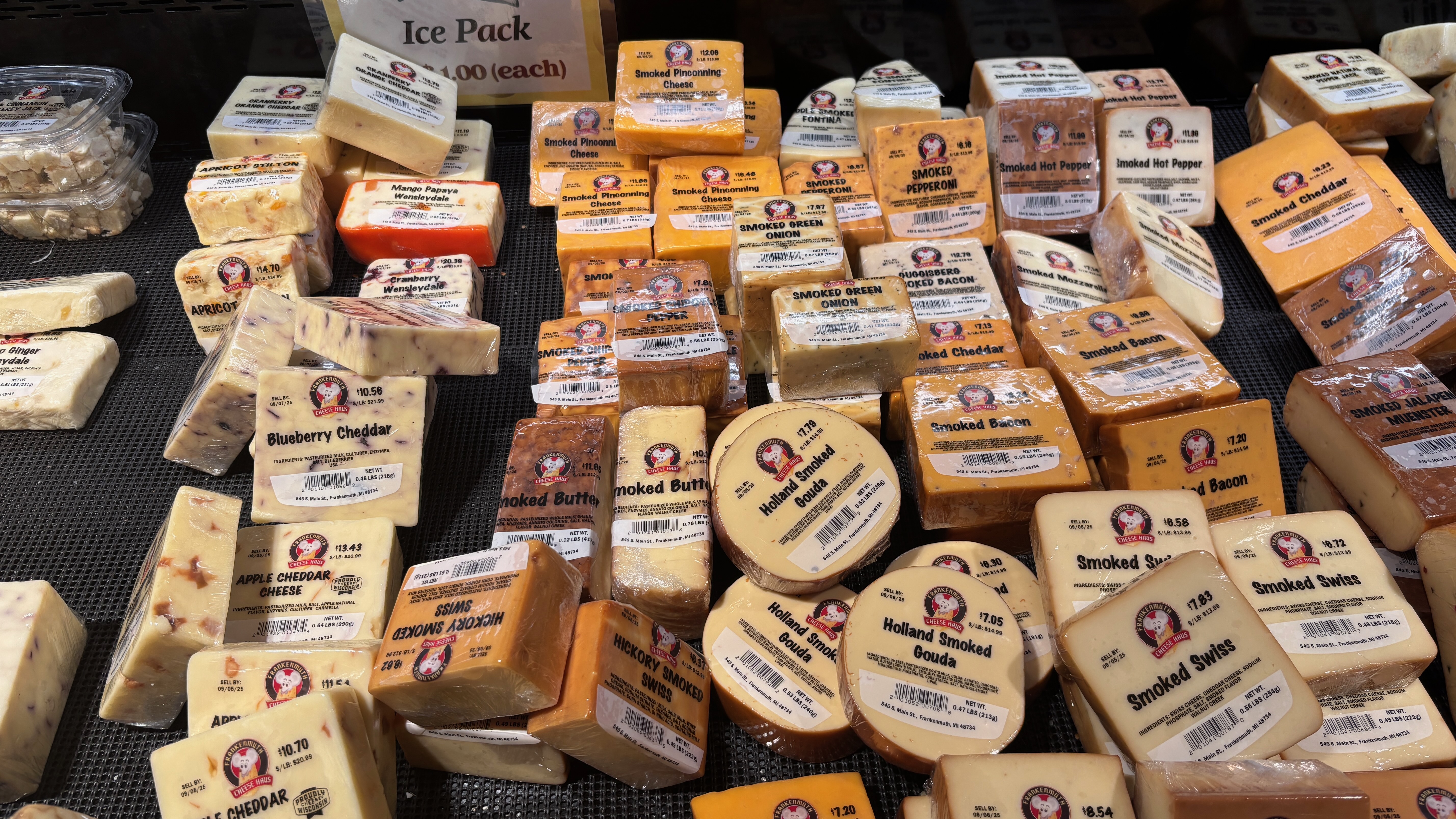 An array of cheeses on display.