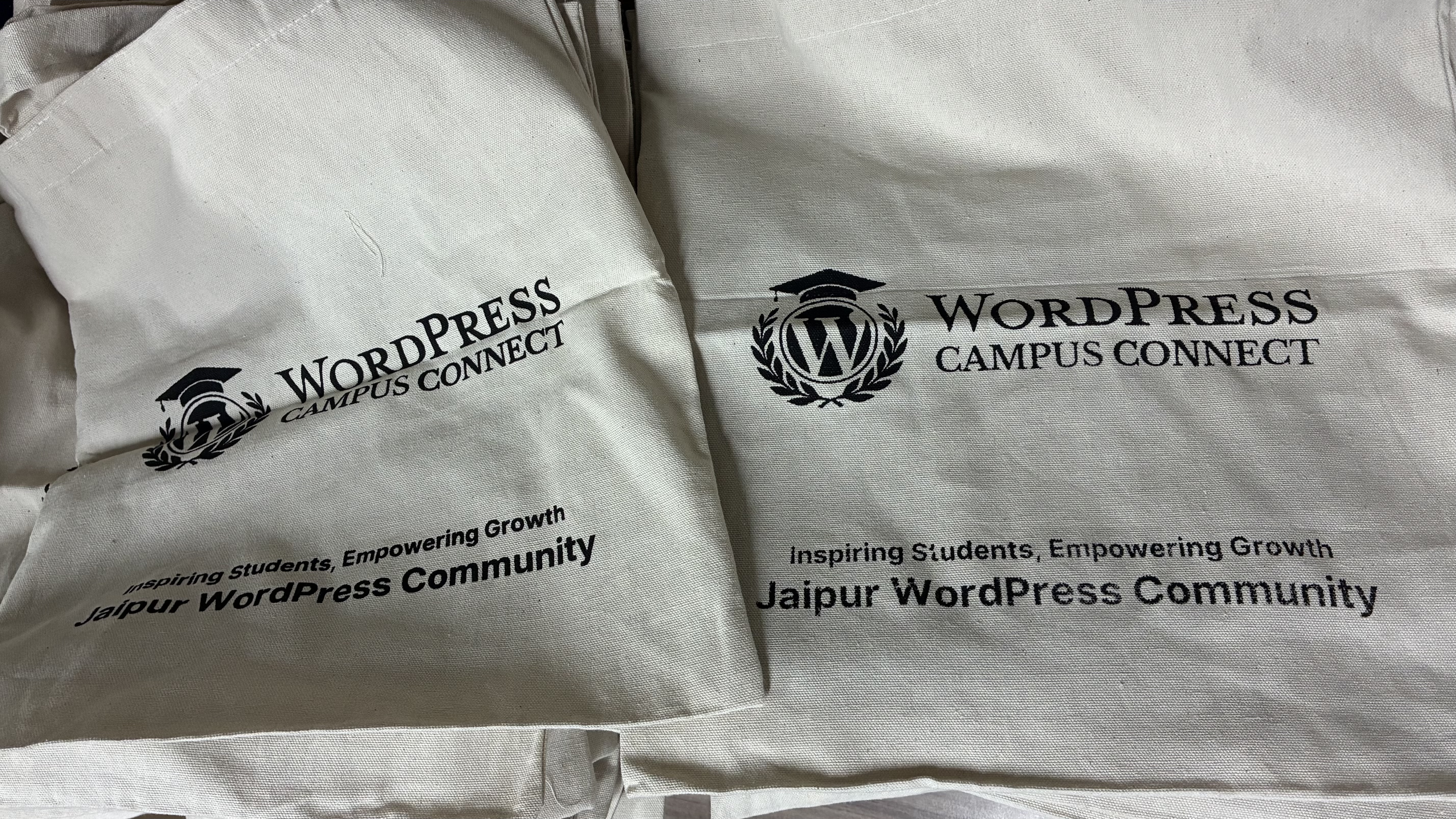 A close-up view of two tote bags, showcasing the WordPress Campus Connect Jaipur program