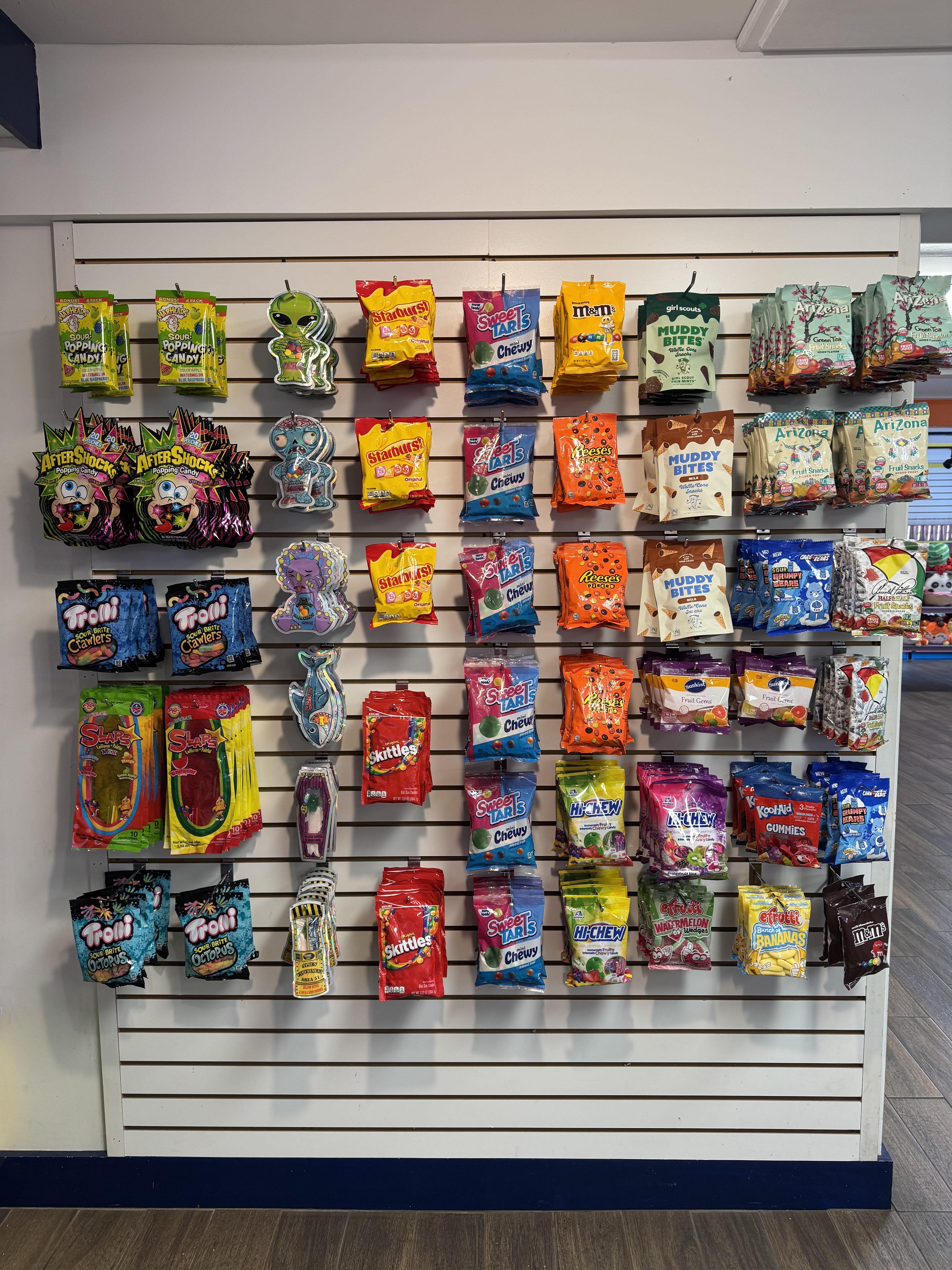 A neatly organized wall of candy bags