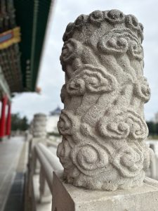 A detailed stone pillar at Chiang Kai-shek Memorial Hall with intricate carvings. 
