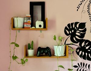 A vibrant pink wall featuring a striking black and white mural adds a bold artistic touch to the space.